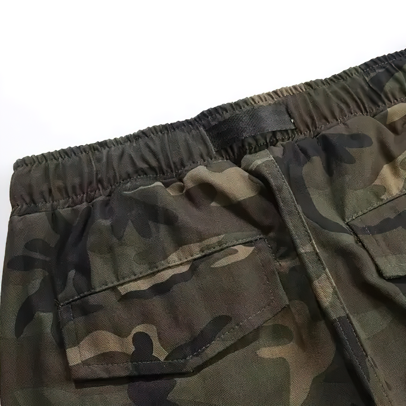Close-up of punk style camouflage cargo pants showing elastic waistband and pockets.