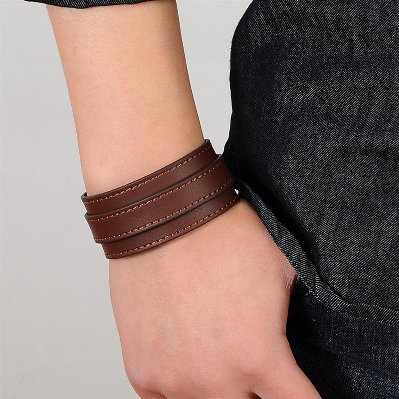 Brown punk style genuine leather wristband on hand, versatile accessory for rock and casual outfits.