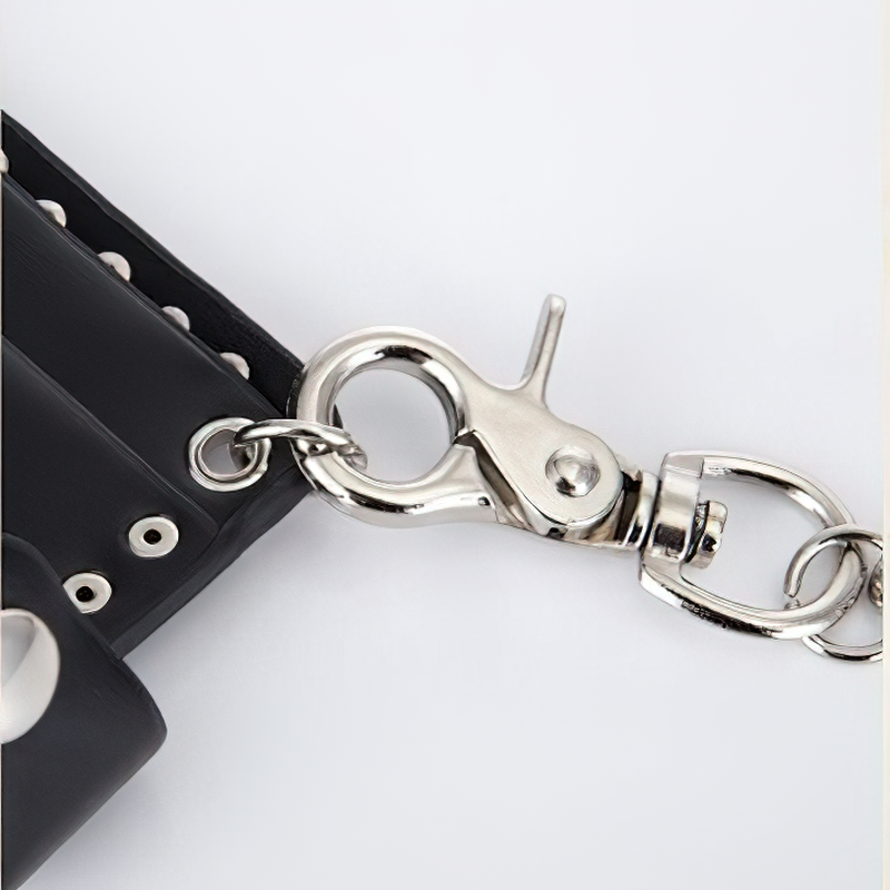 Close-up of the metal clasp and chain on a black punk style wallet with rivets.