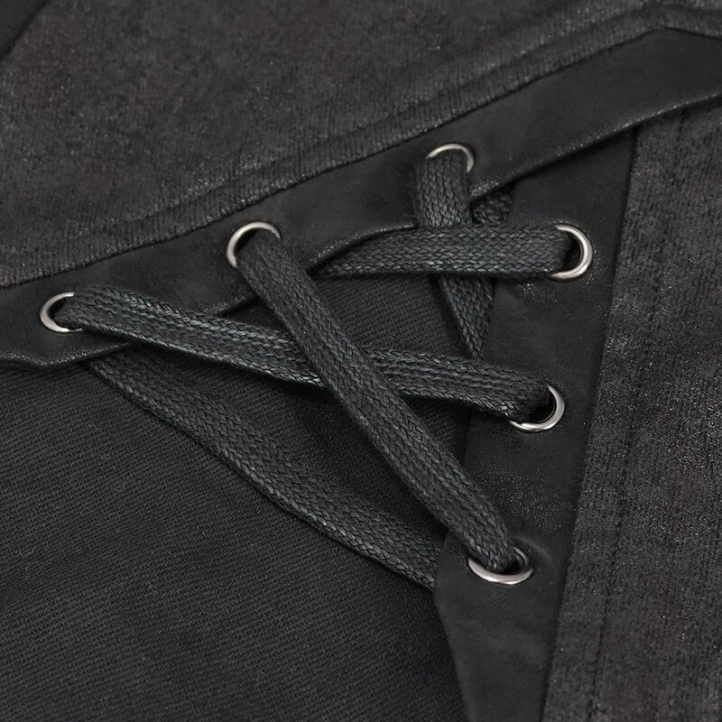 Close-up of lace-up detail on men's punk style black pants with faux leather trim.