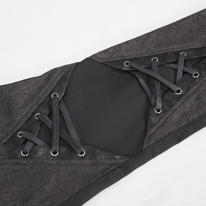 Close-up of punk style black pants with lace-up design and faux leather trim, showcasing edgy fashion details.