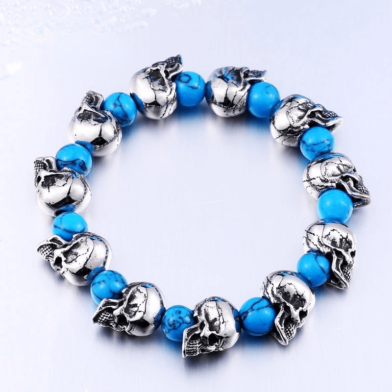 Elastic unisex punk wristband with silver skull head beads and blue accent beads, stylish jewelry accessory.