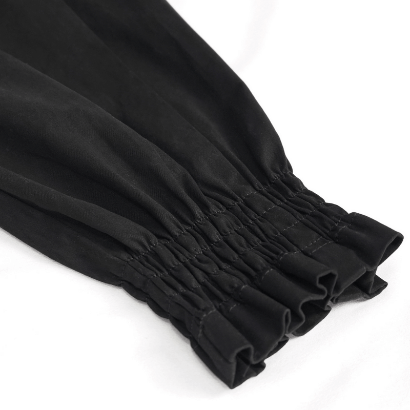 Close-up of black asymmetrical cargo pants featuring gathered elastic cuff detailing.