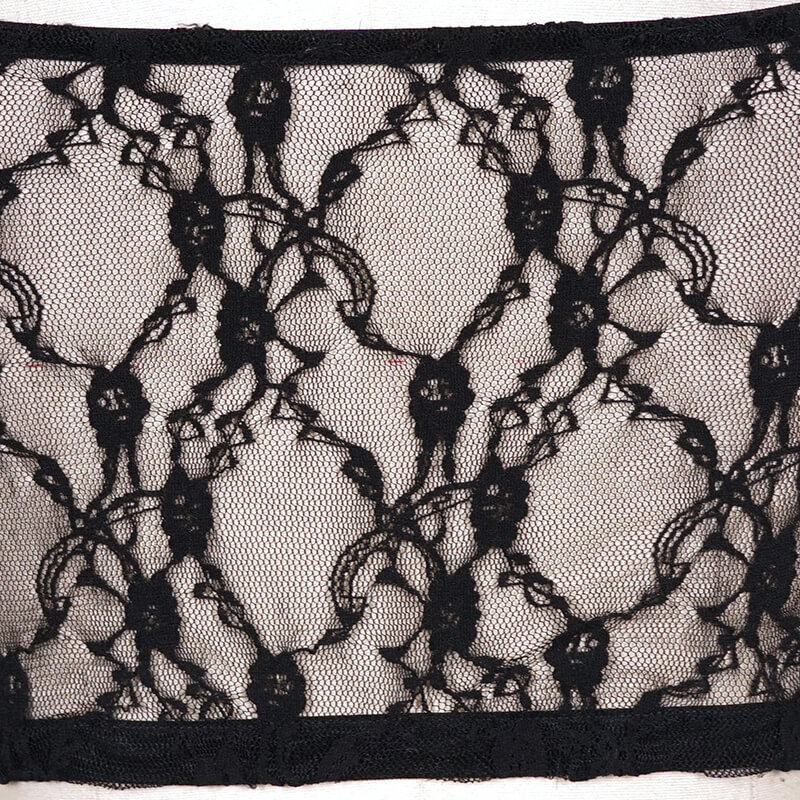 Close-up of intricate black lace fabric featuring floral patterns, ideal for punk style clothing designs.