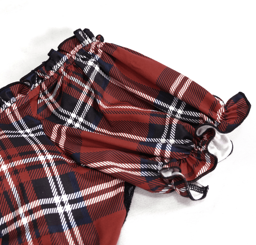 Close-up of the elastic crop top featuring a red and black plaid pattern with stylish puff sleeves.