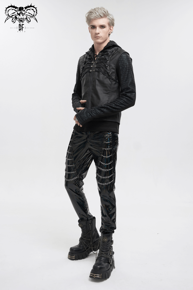 Stylish punk model in a black strappy vest and shiny pants, showcasing a bold gothic fashion statement.
