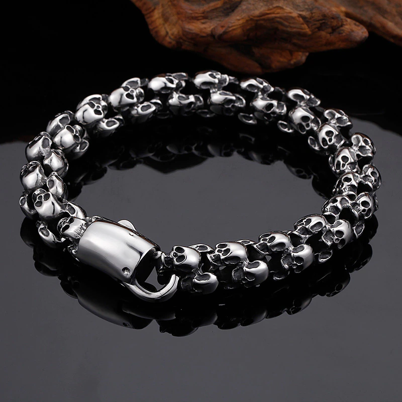 Punk style stainless steel skull bracelet for men, featuring a unique design of skulls, perfect for adding edge to any outfit.