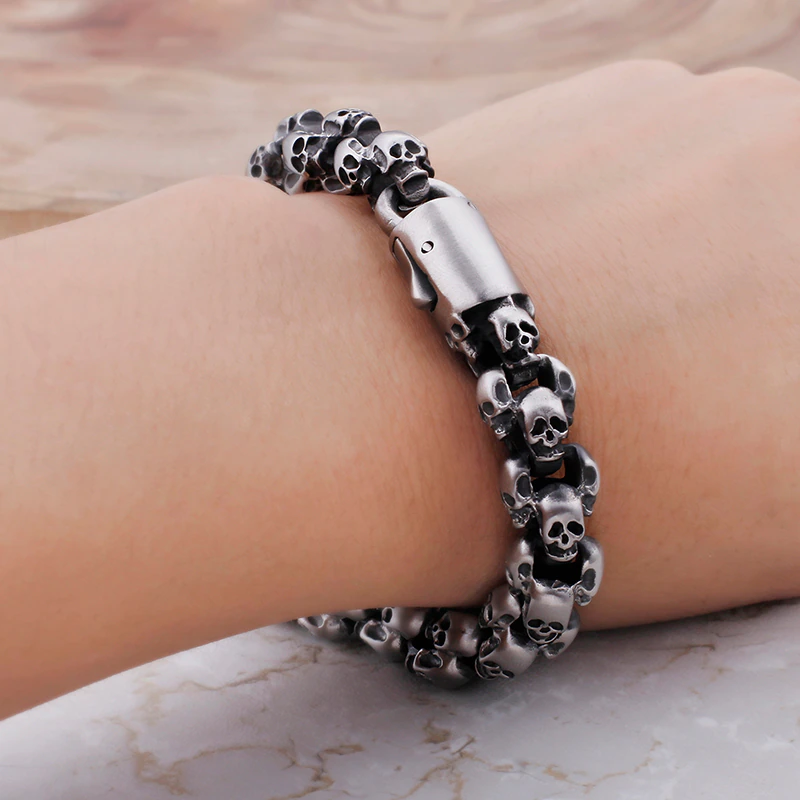 Stylish men's punk skull bracelet made of stainless steel, featuring intricately designed skulls for a cool look.