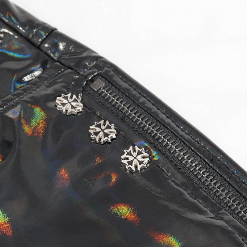 Close-up of black faux leather shorts featuring metallic star studs and shiny zipper detail, perfect for a punk look.