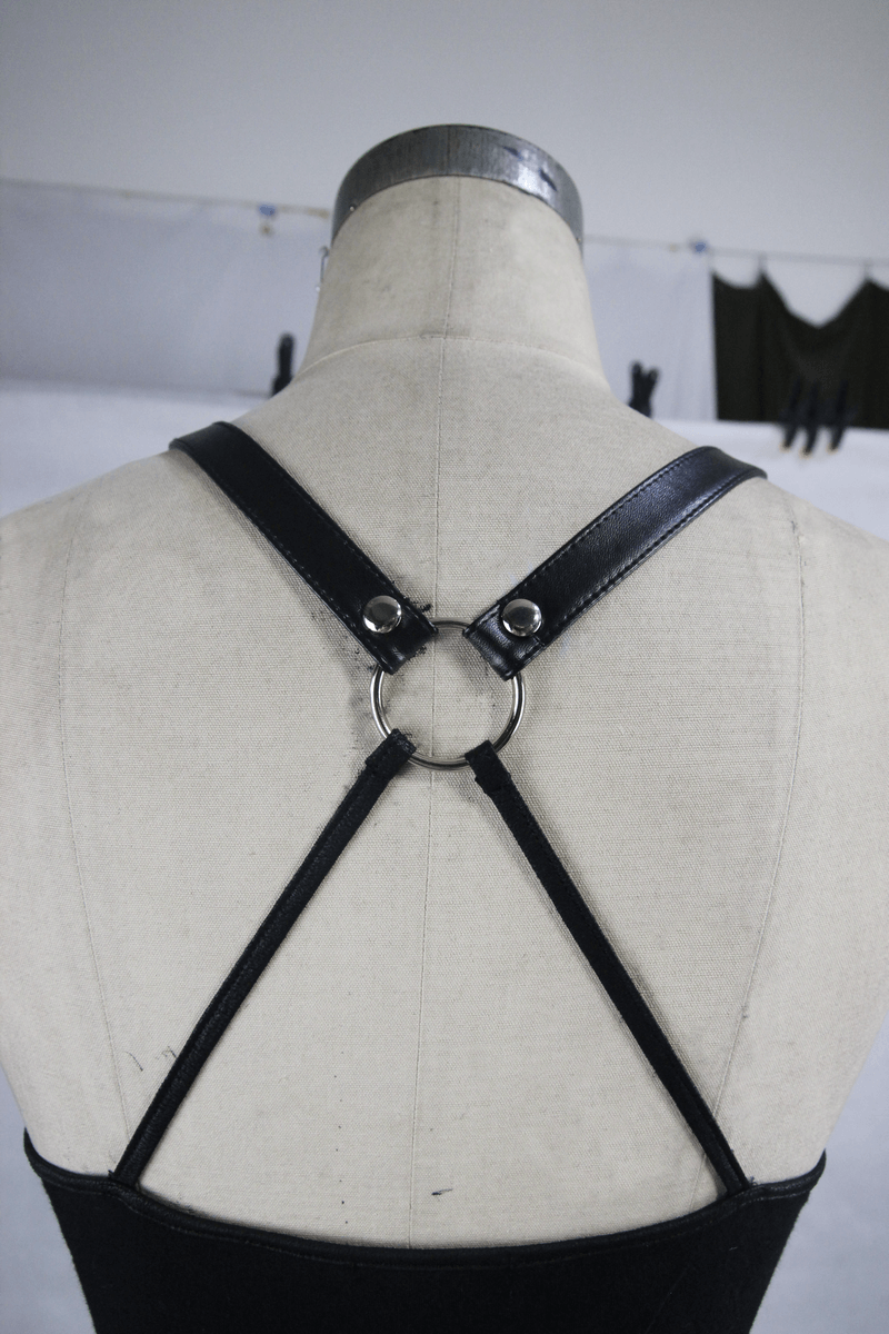 Back view of a punk women's black camisole featuring stylish leather straps and a circular ring detail.