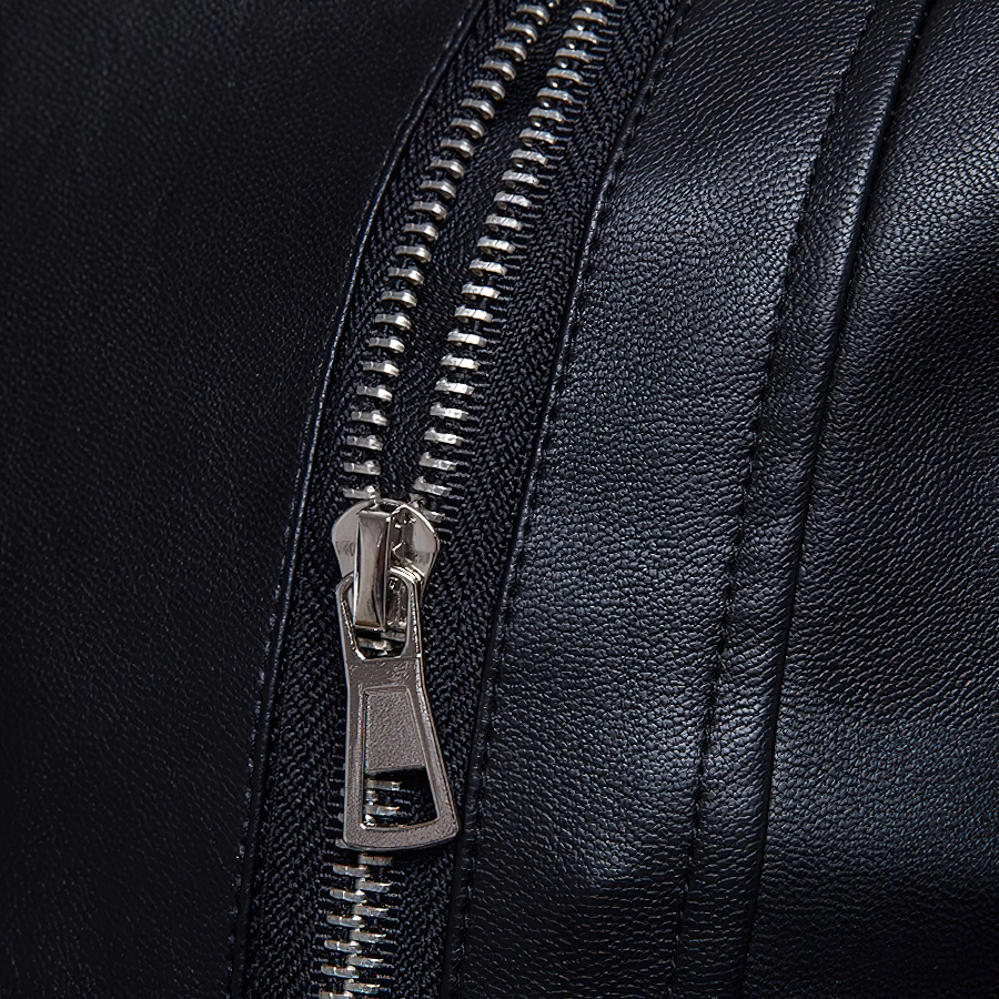 Close-up of a shiny zipper on a black PU leather men's jacket, showcasing stylish punk rock design.