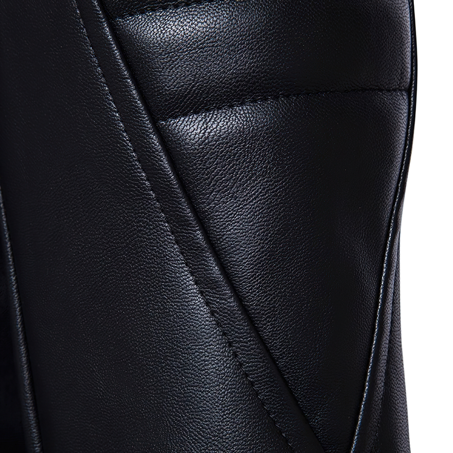 Detail of black PU leather fabric showing sleek texture and stitching of a punk-style men's jacket.