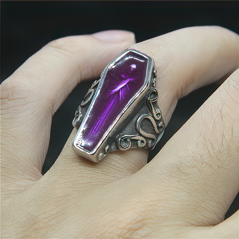 Alternative goth purple coffin mummy ring on a hand, crafted from stainless steel, perfect for a dark, stylish look.