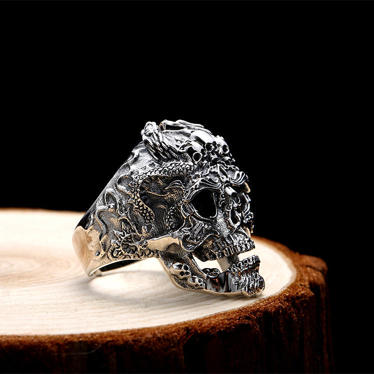 Real 925 sterling silver skull ring on wooden surface, showcasing intricate biker style design for unisex fashion.