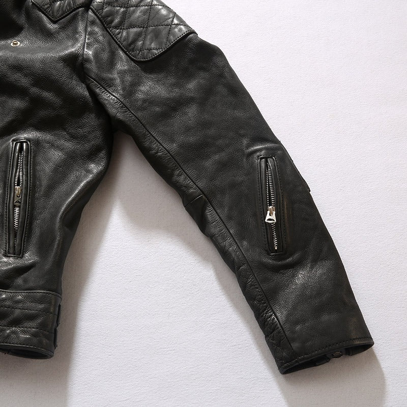 Detail of men's black retro jacket made of cow leather with zippered sleeve pockets and quilted design.