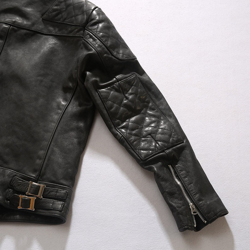Close-up of a black retro leather jacket sleeve with quilted design and metal zip detail, perfect for bikers.