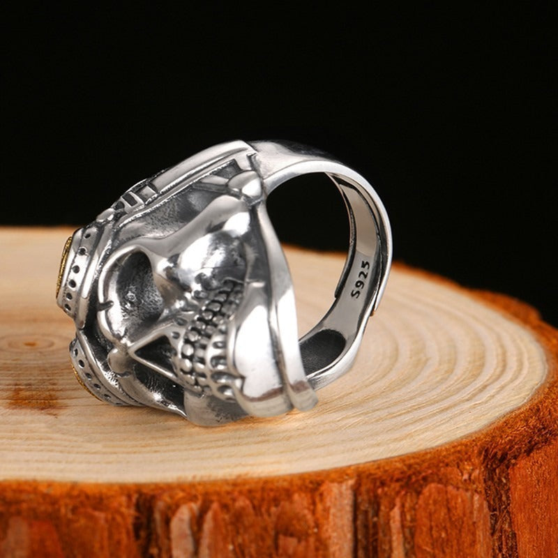 925 silver aviator skull ring resting on a wooden slice, showcasing its heavy vintage design for unisex biker jewelry.