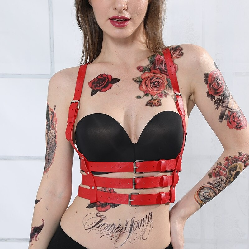 Red PU leather gothic harness on model with tattoos, featuring stylish silver fittings and high-waisted design.