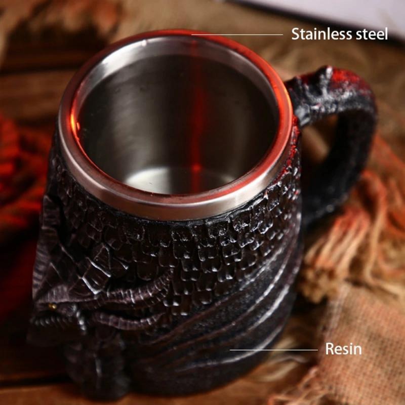 Vintage resin and stainless steel beer mug featuring dragon design, perfect for Viking pub theme.