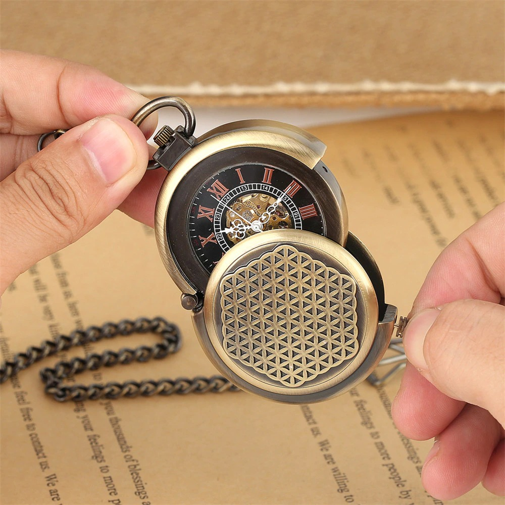 Retro bronze mechanical pocket watch with Roman numeral display, held in hands, showcasing its vintage design.