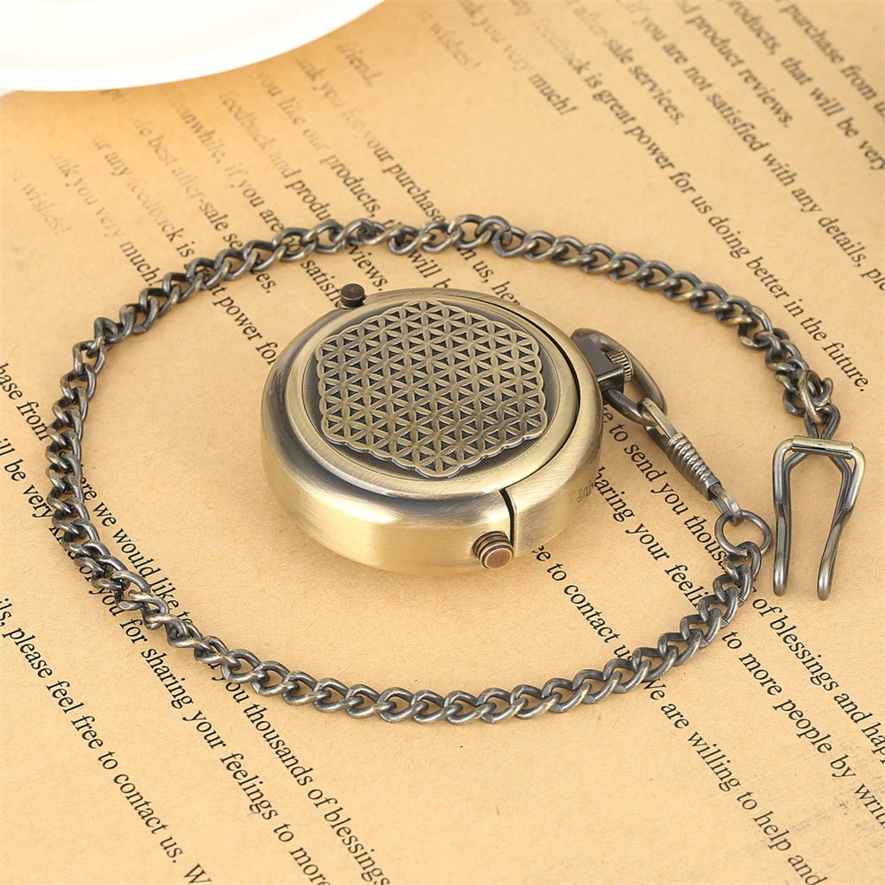 Retro bronze mechanical pocket watch with chain on vintage paper background.