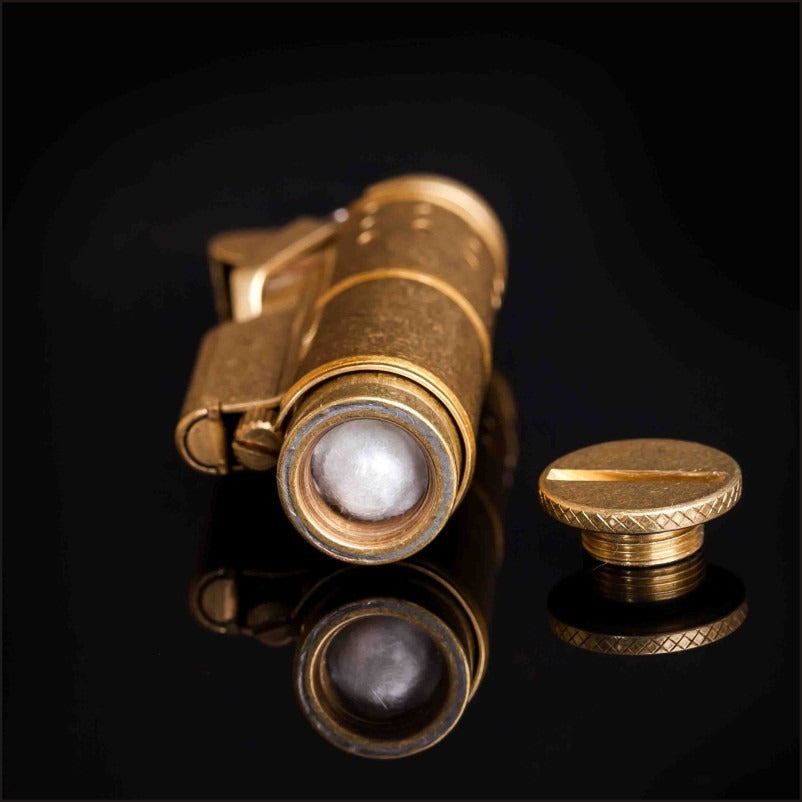 Close-up of a retro gasoline flint lighter in pure copper with a cap, showcasing vintage design and practicality.