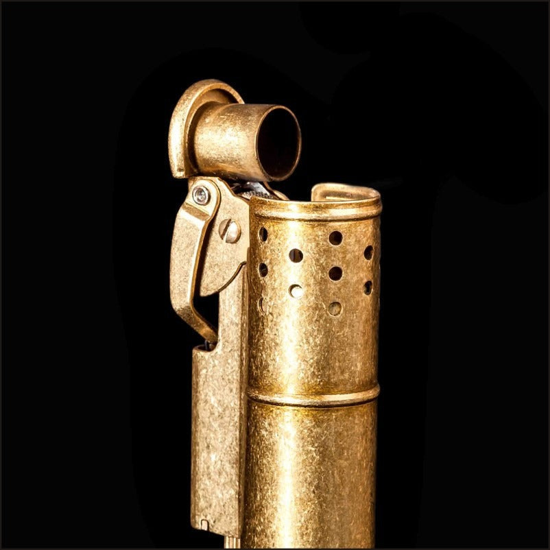 Close-up of a retro gasoline flint lighter in brass finish, showcasing vintage design and metal craftsmanship.
