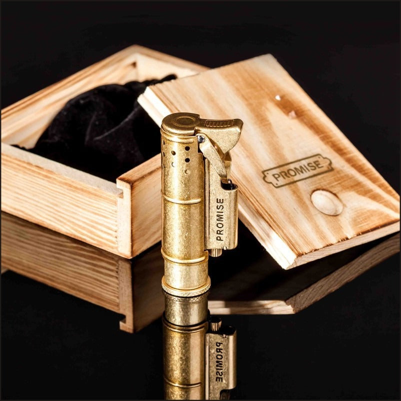Retro Gasoline Flint Lighter in brass finish next to wooden box with velvet interior, showcasing vintage style and practicality.