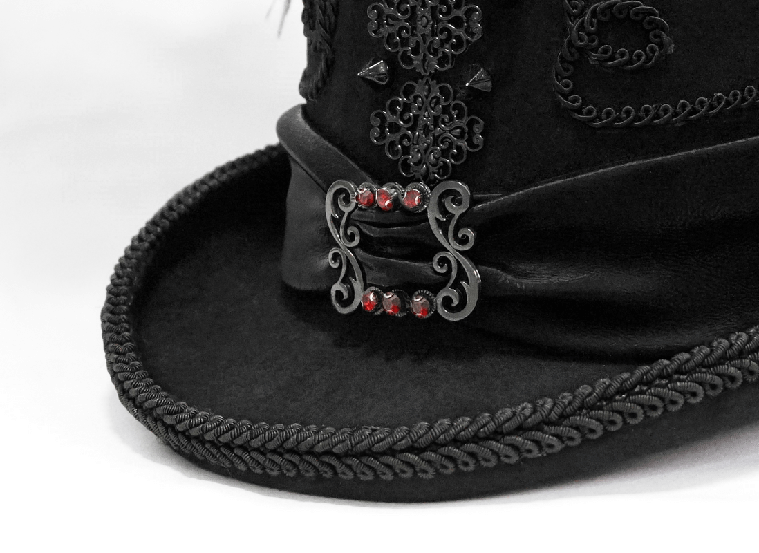 Close-up of a vintage black gothic hat adorned with lace and rhinestone accents for a stylish touch.