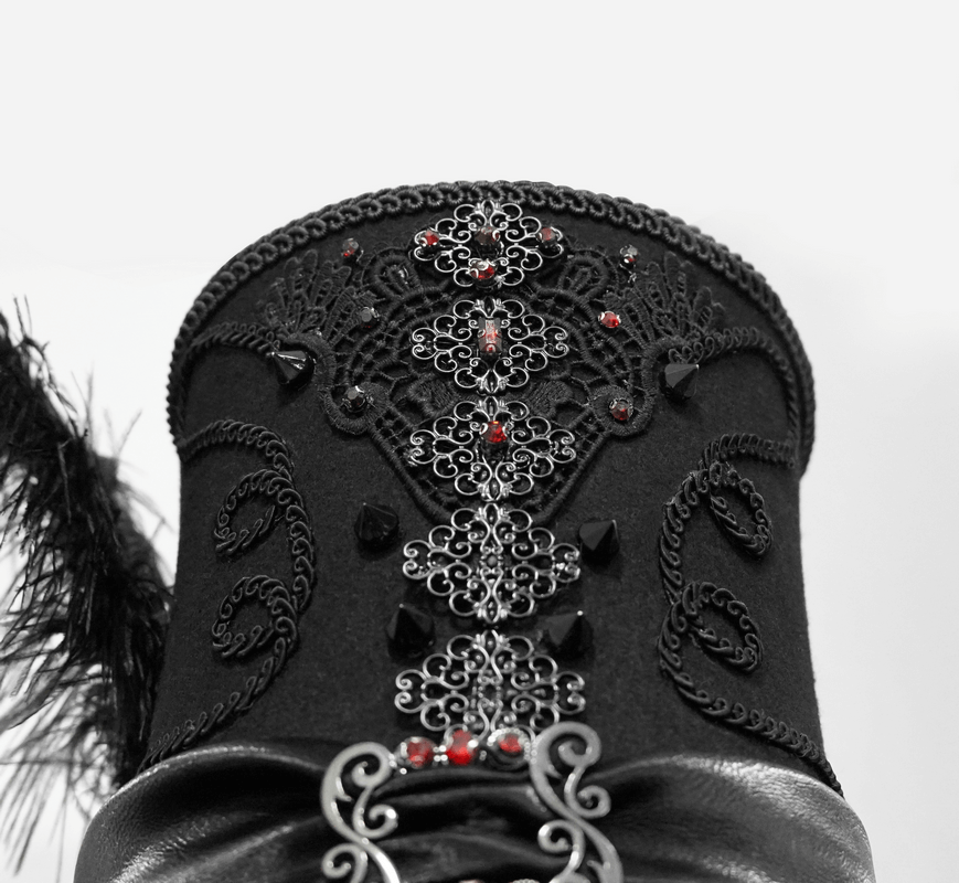 Close-up of a vintage black gothic hat featuring intricate lace appliques and red rhinestones for a dramatic look.