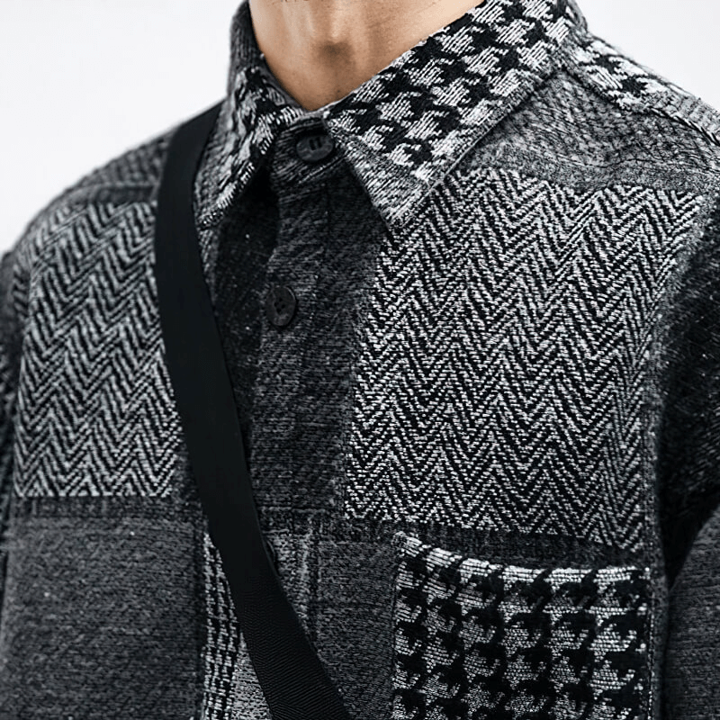 Close-up of a man's retro woolen plaid shirt showcasing stylish black and white patterns and buttons.