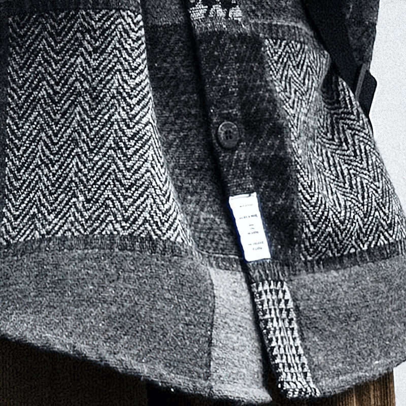 Close-up of a men's retro woolen plaid shirt showcasing stylish buttons and unique fabric patterns.