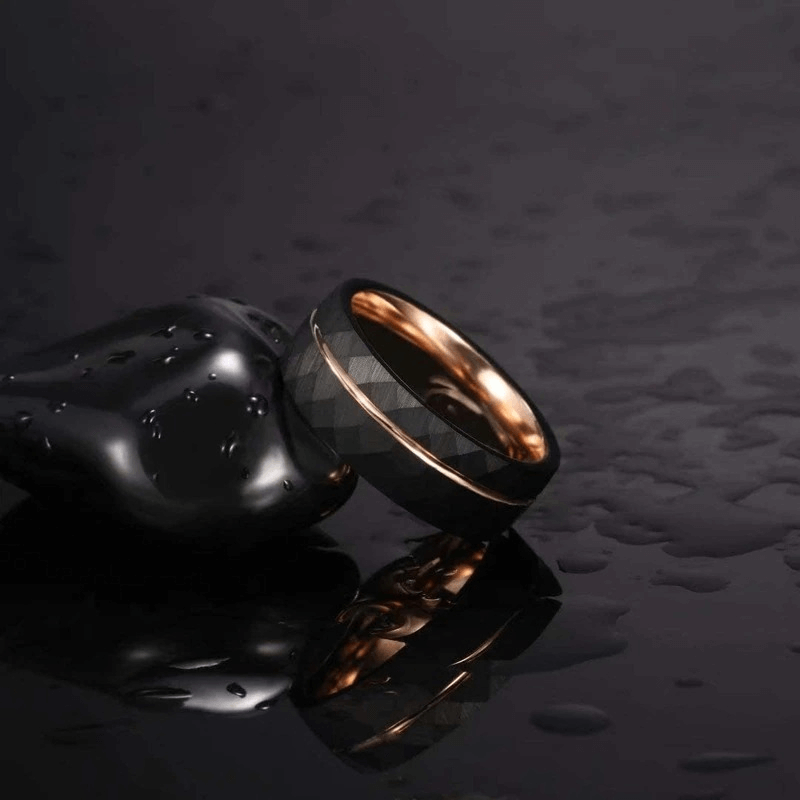 Stylish unisex rhombus patterned tungsten steel ring with a golden groove, resting on a sleek black surface.