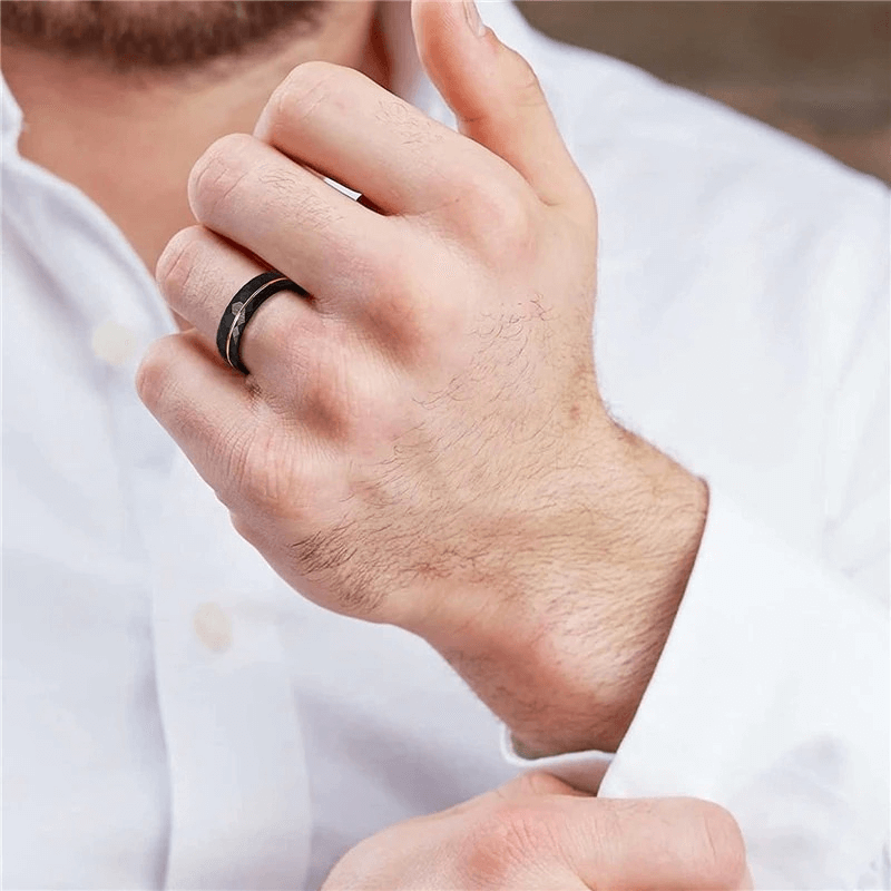 Close-up of a hand wearing a stylish rhombus patterned tungsten steel band ring, showcasing cool retro jewelry.