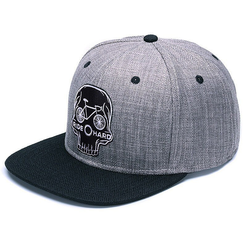 Ride Hard Skull Baseball Cap with embroidered skull and bicycle graphic, perfect for edgy rock style and biker enthusiasts.