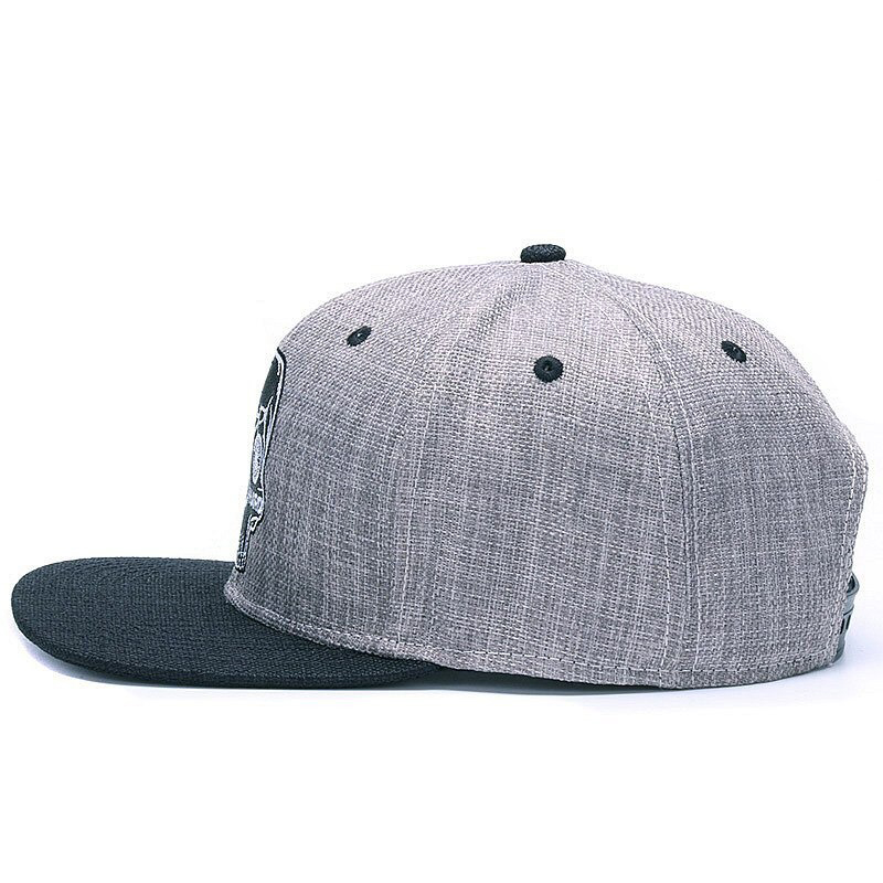 Ride Hard Skull Baseball Cap side view, snapback hat with skull embroidery, edgy biker style accessory.