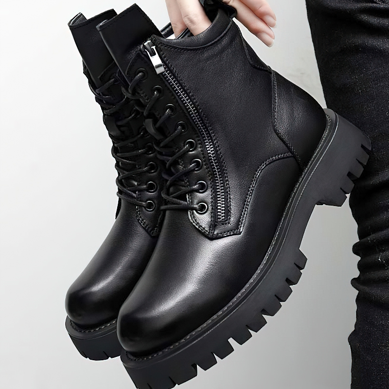 Stylish men's black leather ankle boots with lace-up design and flexible sole, perfect for casual rock style fashion.