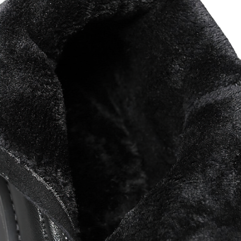 Interior view of black leather ankle boots showcasing soft, warm lining for comfort and style in men's rock footwear.