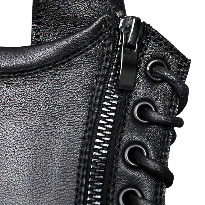 Close-up of stylish black leather ankle boot featuring zipper and laces, perfect for casual rock-style wear.