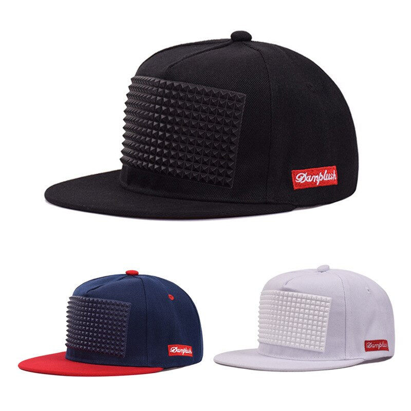Rock style baseball caps with plastic spikes in black, navy, and white; flat-brimmed unisex snapbacks for fashion-forward looks.