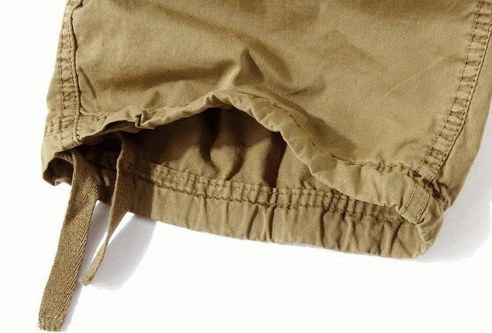 Close-up of the hem of loose camouflage cargo shorts, showcasing adjustable drawstring design for a comfortable fit.