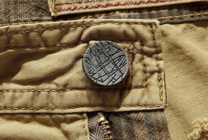 Close-up of a stylish bronze button on men's loose cargo shorts, showcasing rock style and durability.