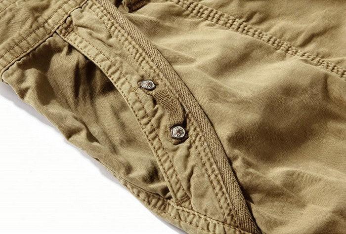 Close-up of loose camouflage cargo shorts with buttons, showcasing practical pockets and rock style.