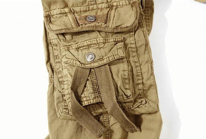 Military-style loose cargo shorts with multiple pockets and zippers in camouflage design for men.