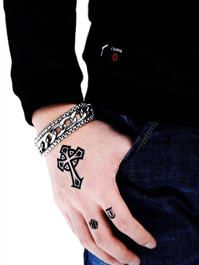 Stylish stainless steel chain bracelet worn on a hand with tattoos, showcasing a rock-inspired fashion statement.
