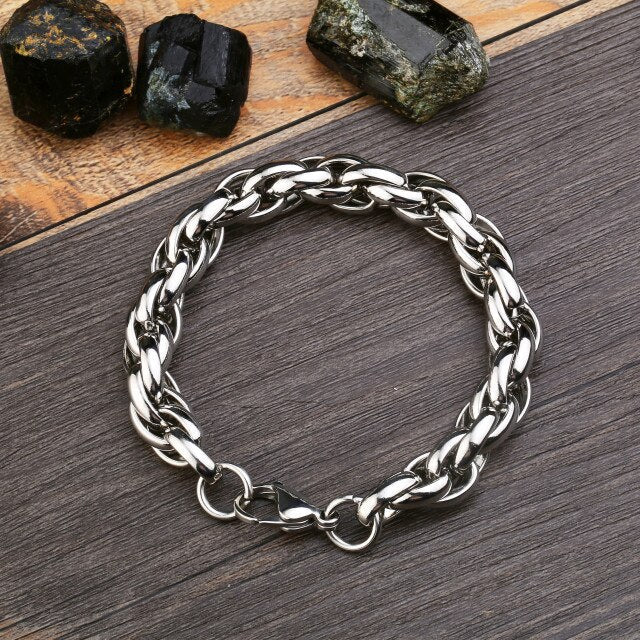 Rock style stainless steel chain bracelet on wood with gemstones, perfect trendy accessory for bold fashion lovers.