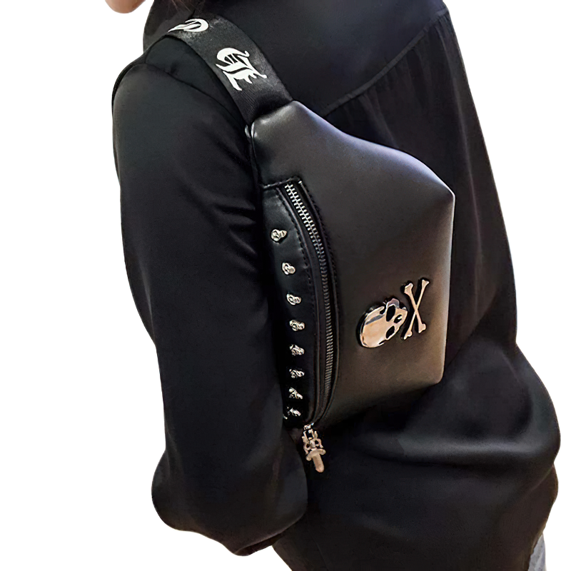 Unisex rock style crossbody bag with skull and rivets worn on the shoulder, perfect trendy accessory for men and women.