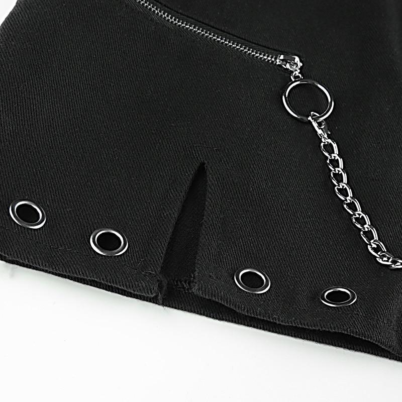 Close-up of a black high waist mini skirt featuring a ring chain and grommet details for a stylish rock-inspired look.