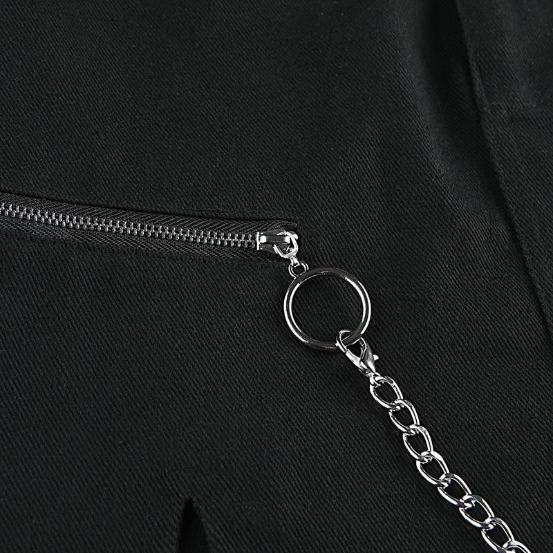 Close-up of black skirt featuring ring chain and zipper detail for a trendy rock style look.