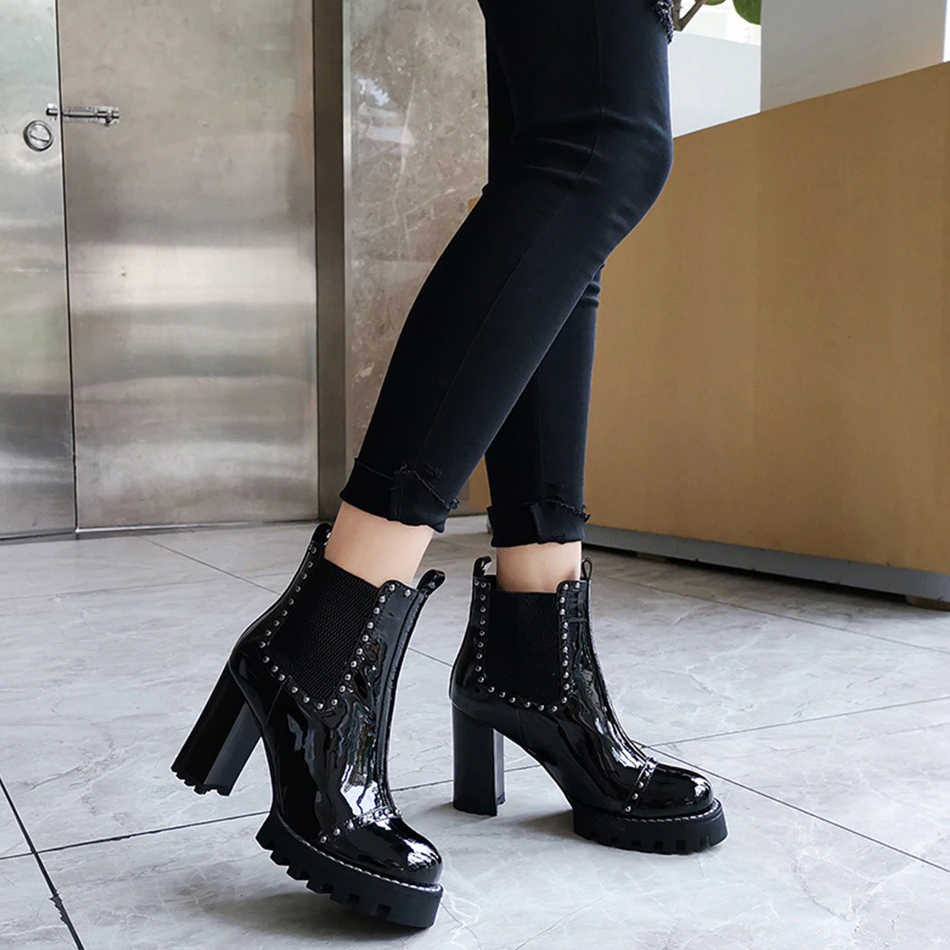 Stylish black leather ankle boots with high heels and rivets, perfect for creating a rock chic outfit.
